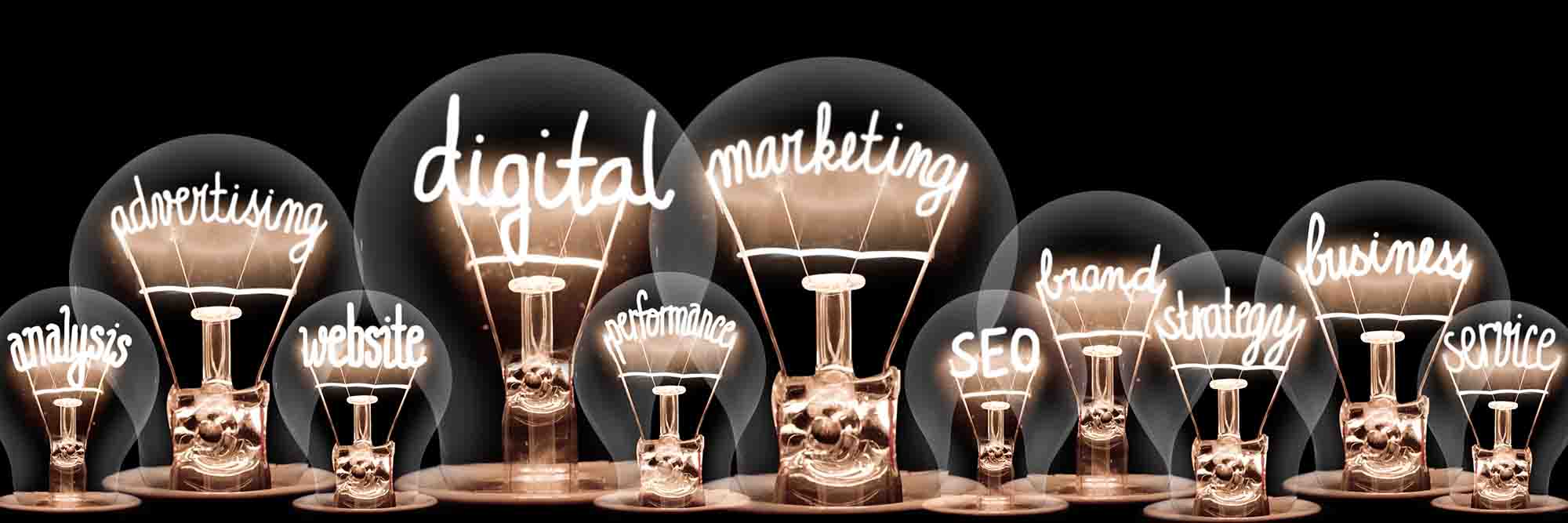 Lightbulbs with words indicating content marketing against a black background.
